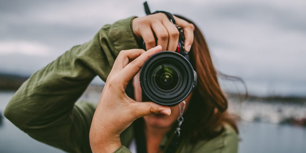 Young woman using DSLR camera Young woman using DSLR camera